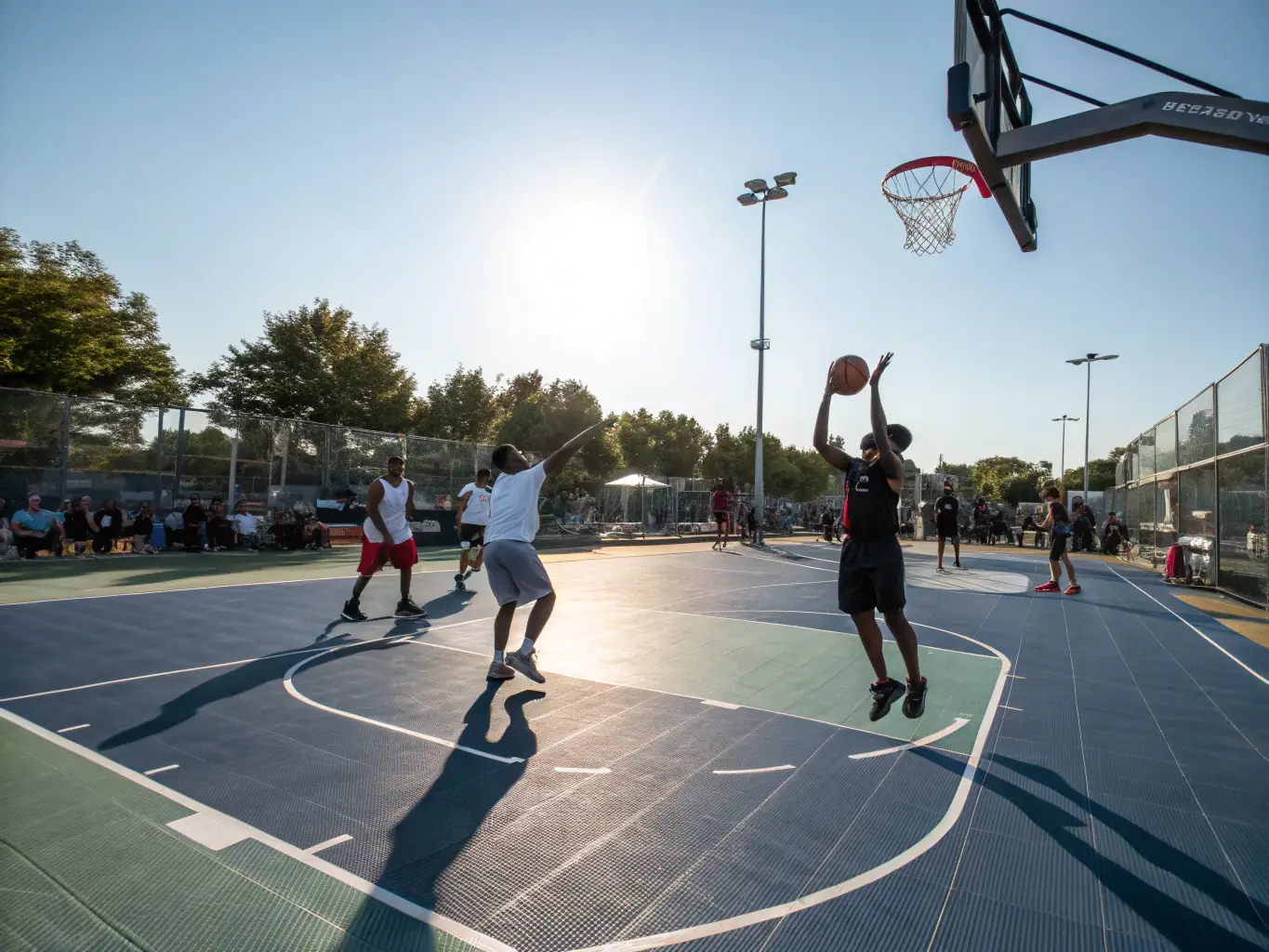 An action shot of adults playing basketball in an indoor gymnasium, emphasizing fitness, competition, and camaraderie.